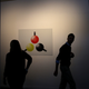 Attendees walk by a poster with an image of the new Google Chromecast during a Google media event on September 29, 2015 in San Francisco, California.